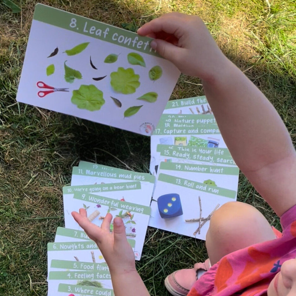 Child looking through the Outdoor Play Activity Cards